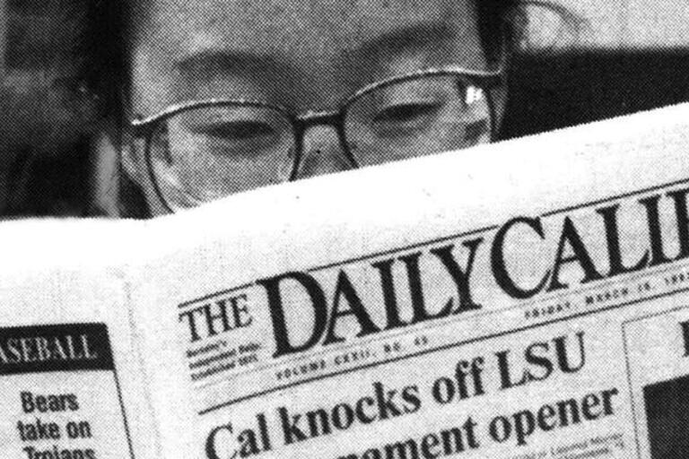 Photograph of someone reading a copy of The Daily Californian.
