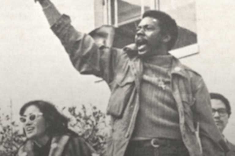 Image from the Berkeley Revolution Website of a man with his fist in the air