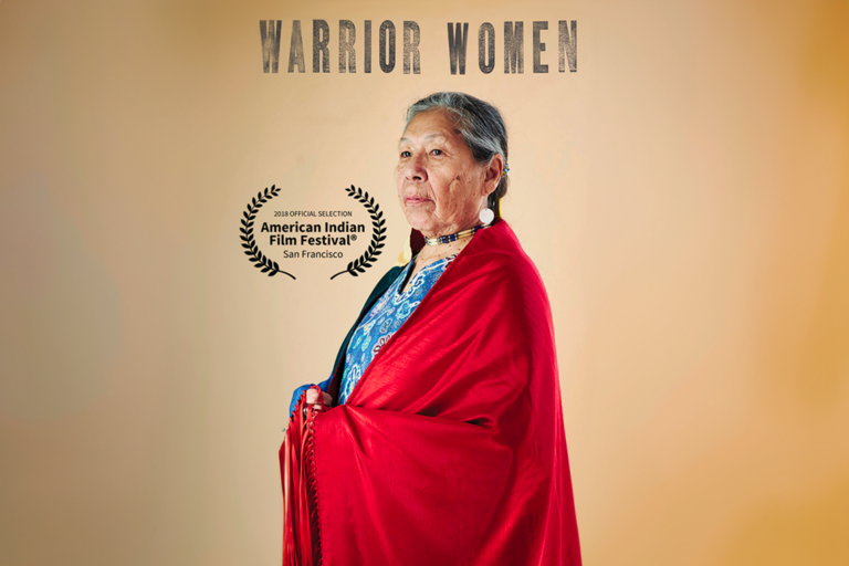 An indigenous activist woman in a red robe 