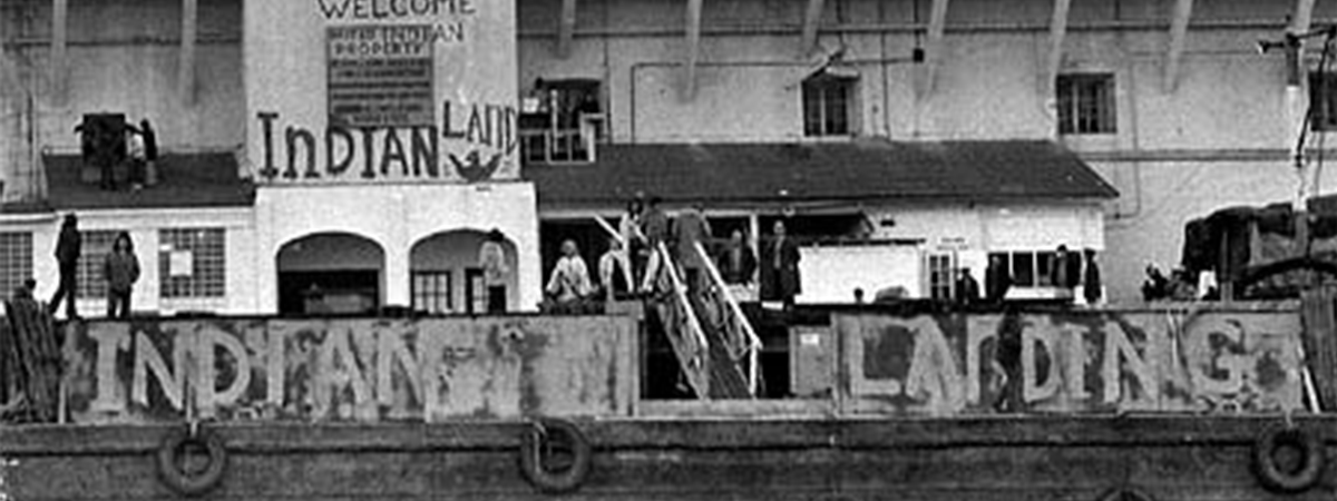 Image of Occupation of Alcatraz Protest, American Indians at Alcatraz entrance, in front of wall that says Indian Land